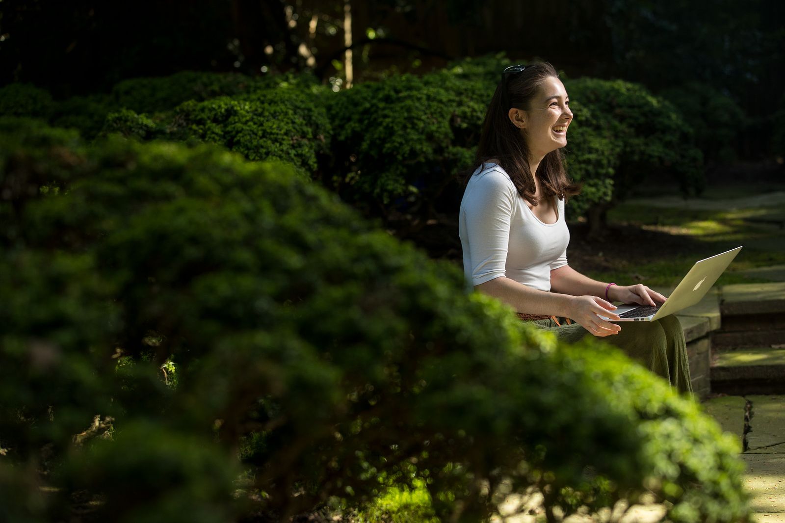 Student working on computer outside